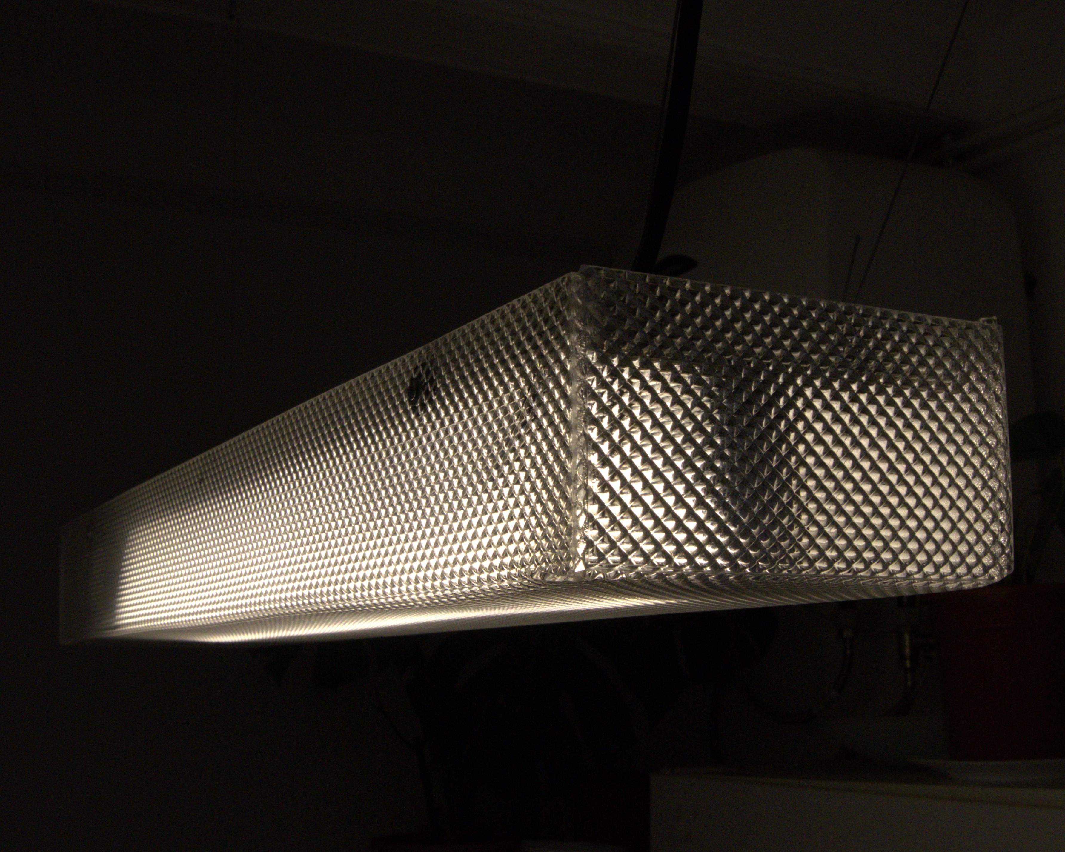 Illuminated Prisma Lamp showing its prismatic methacrylate enclosure